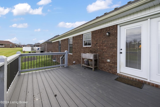 wooden terrace with a lawn