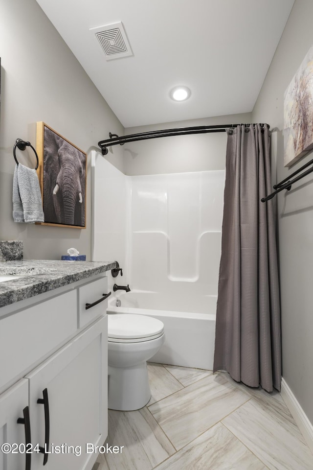 full bathroom with vanity, shower / bath combo, and toilet