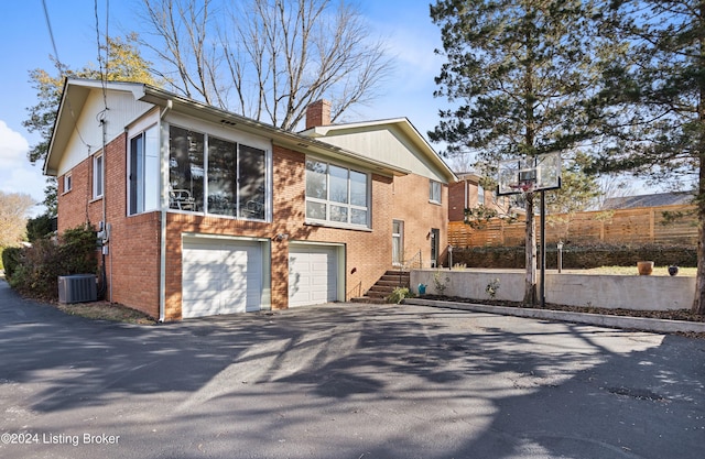 view of side of property with central AC and a garage