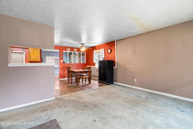 interior space featuring carpet flooring, ceiling fan, and a textured ceiling