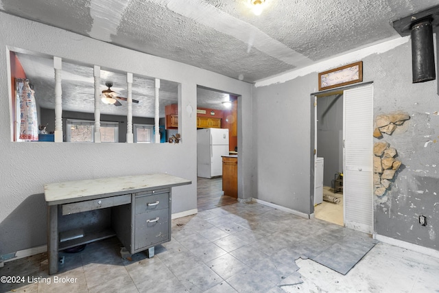 office with a textured ceiling and ceiling fan