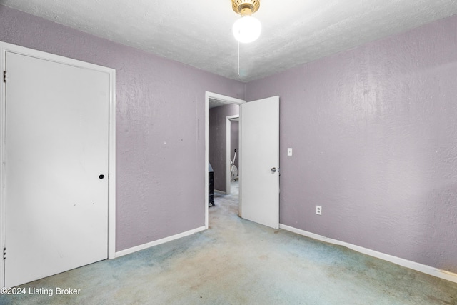 unfurnished bedroom with a textured ceiling