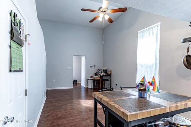 office area with ceiling fan, dark hardwood / wood-style floors, and vaulted ceiling