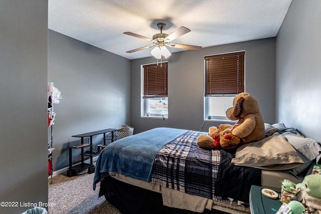 bedroom with ceiling fan and carpet flooring