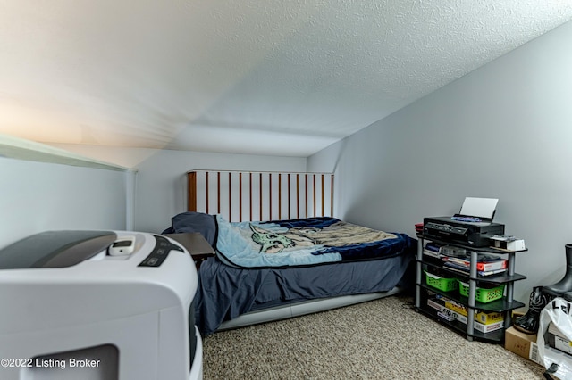 bedroom featuring carpet floors and a textured ceiling