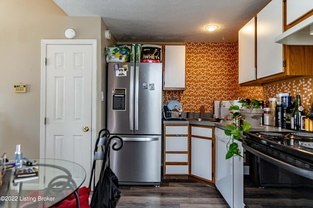 kitchen with black / electric stove, backsplash, white cabinetry, and stainless steel fridge