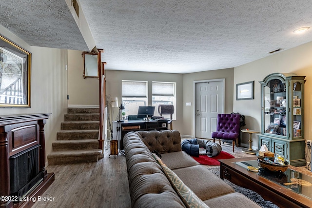 living room featuring hardwood / wood-style flooring and a textured ceiling