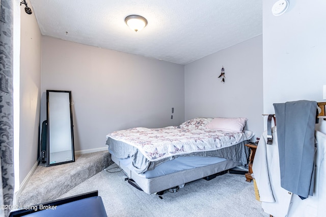 carpeted bedroom featuring a textured ceiling