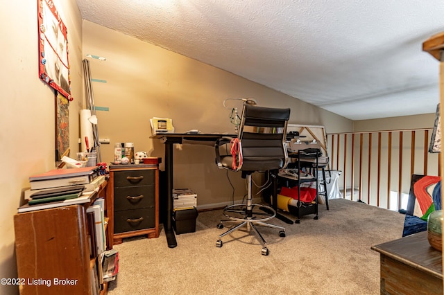 office featuring a textured ceiling, carpet, and vaulted ceiling