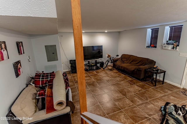 living room with a textured ceiling, electric panel, and dark tile patterned floors