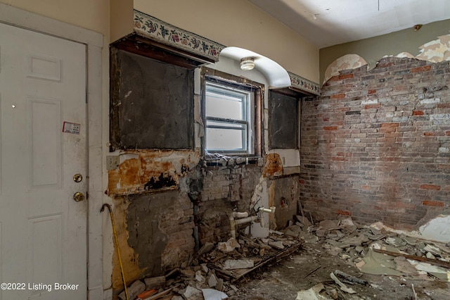 miscellaneous room featuring brick wall