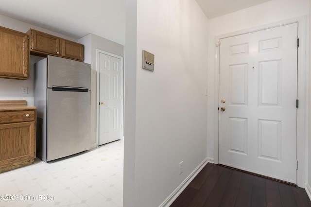 interior space with stainless steel refrigerator and light hardwood / wood-style flooring