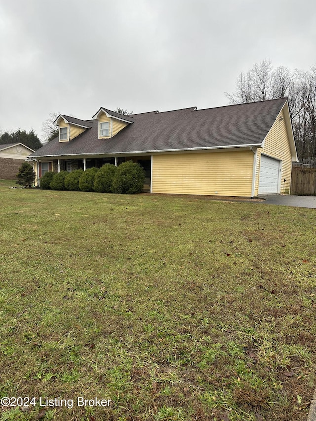 view of front of house with a garage and a front lawn