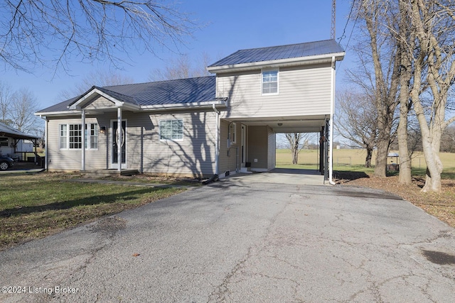 view of front of home with a front lawn and a carport