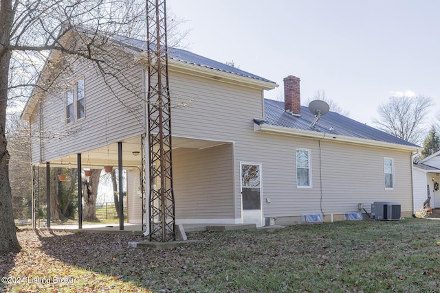 rear view of house with central air condition unit