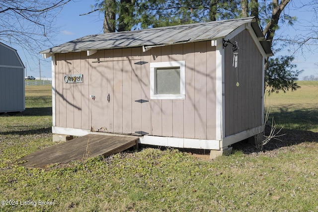 view of outbuilding with a lawn