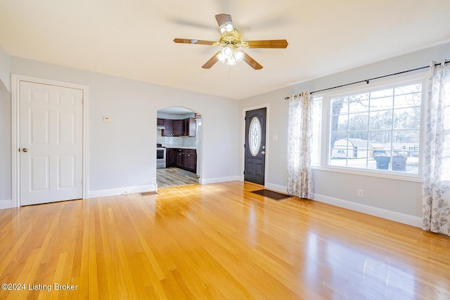 unfurnished living room featuring light wood-type flooring and ceiling fan