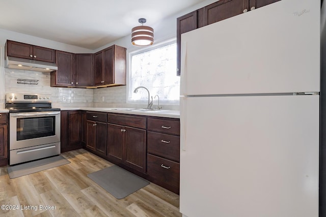 kitchen with sink, electric range, decorative backsplash, light hardwood / wood-style floors, and white fridge