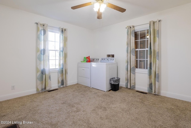 laundry room featuring washer and dryer, ceiling fan, and light carpet