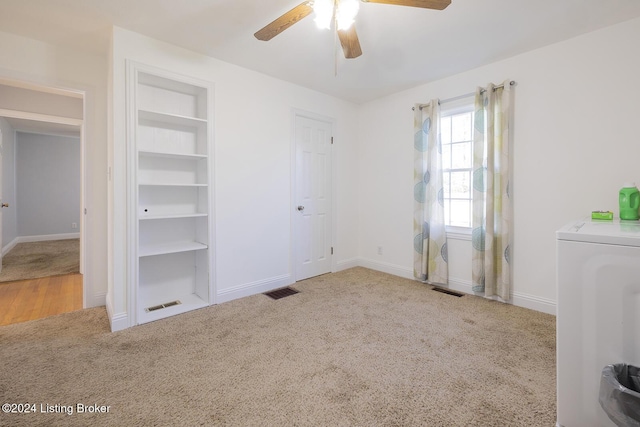 unfurnished bedroom with ceiling fan, light carpet, and washer / clothes dryer