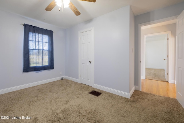 spare room featuring carpet flooring and ceiling fan