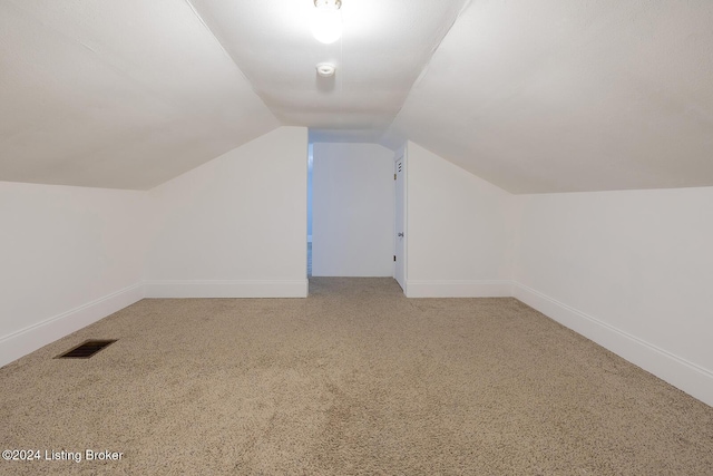 bonus room featuring carpet floors and vaulted ceiling