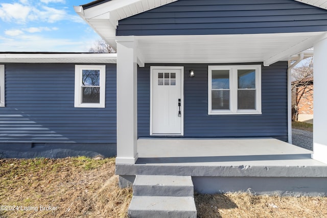 view of exterior entry with covered porch