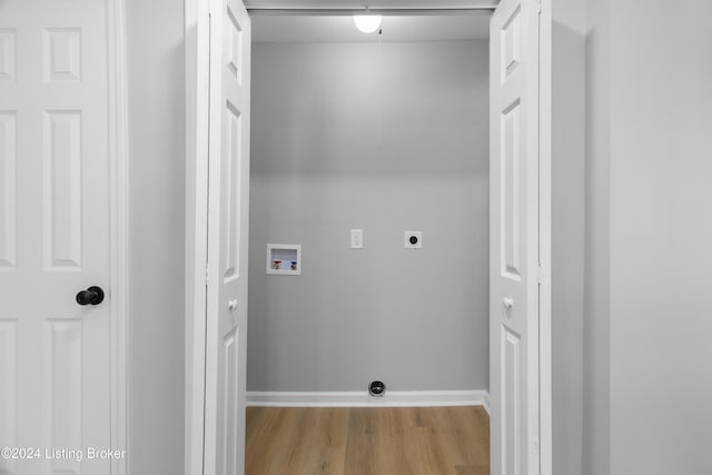 washroom featuring washer hookup, light hardwood / wood-style floors, and hookup for an electric dryer