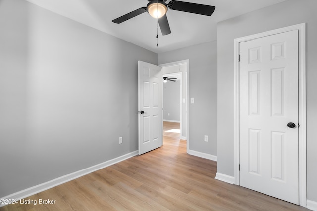 unfurnished bedroom featuring ceiling fan and light wood-type flooring