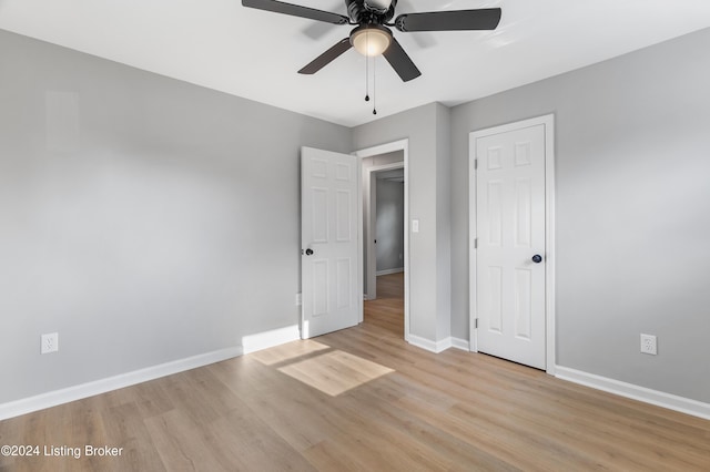 unfurnished bedroom featuring ceiling fan and light wood-type flooring