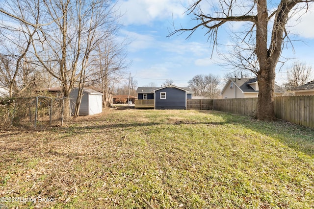 view of yard with a storage shed and a wooden deck