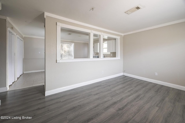 unfurnished room featuring dark hardwood / wood-style floors and ornamental molding