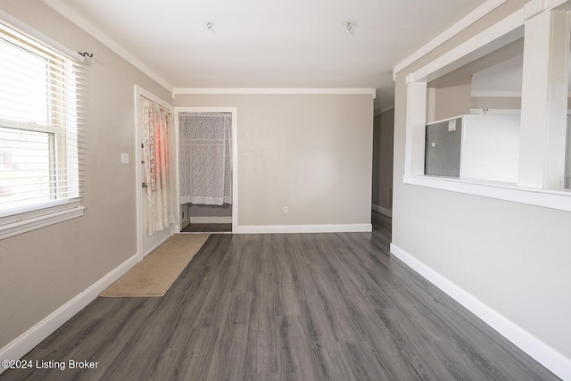 unfurnished room with dark hardwood / wood-style floors and ornamental molding