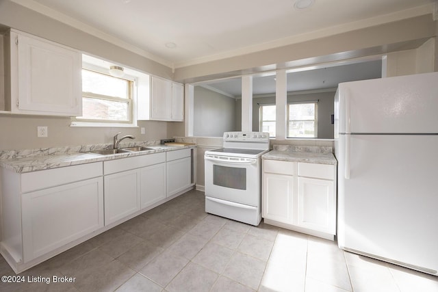 kitchen featuring white appliances, white cabinetry, plenty of natural light, and sink