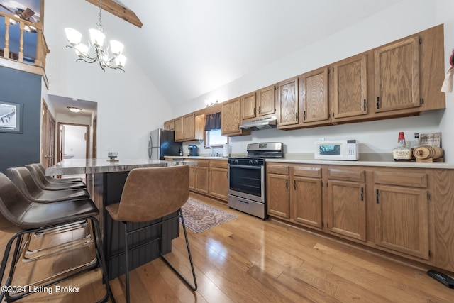 315 Timberlake Ln, Mcdaniels, KY 40152 - kitchen with appliances with stainless steel finishes, under cabinet range hood, high vaulted ceiling, a chandelier, and brown cabinets