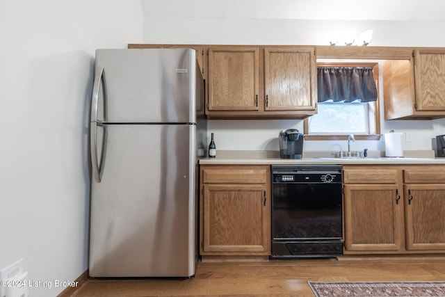 315 Timberlake Ln, Mcdaniels, KY 40152 - kitchen featuring freestanding refrigerator, black dishwasher, light countertops, light wood-style flooring, and brown cabinetry