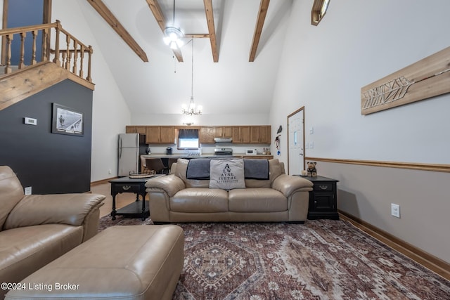 carpeted living room with beamed ceiling, ceiling fan with notable chandelier, and high vaulted ceiling