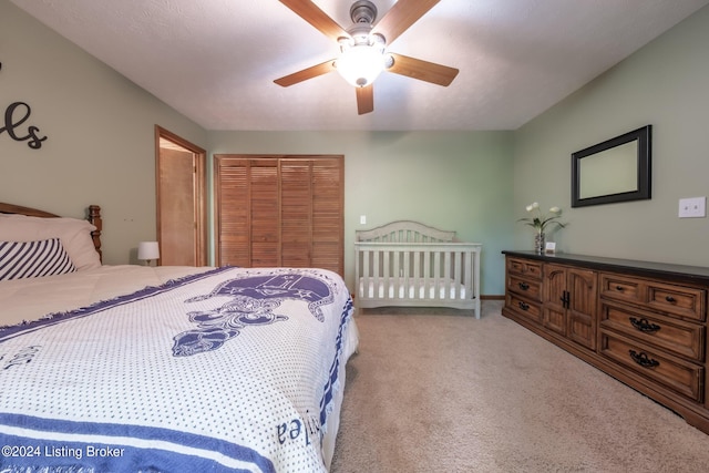 bedroom featuring light carpet, a closet, and ceiling fan