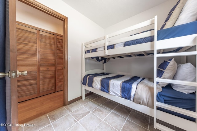 tiled bedroom with a closet