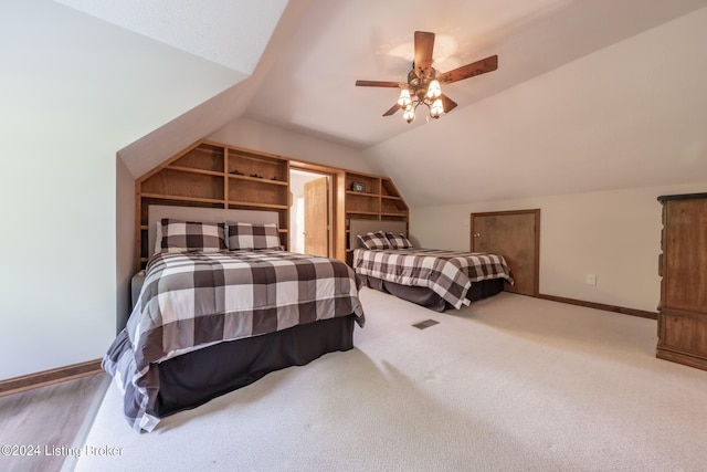 bedroom featuring carpet, ceiling fan, and vaulted ceiling