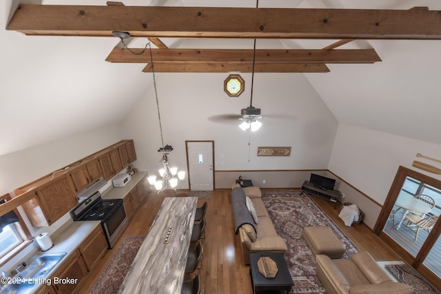 living room featuring beamed ceiling, ceiling fan with notable chandelier, high vaulted ceiling, and dark wood-type flooring