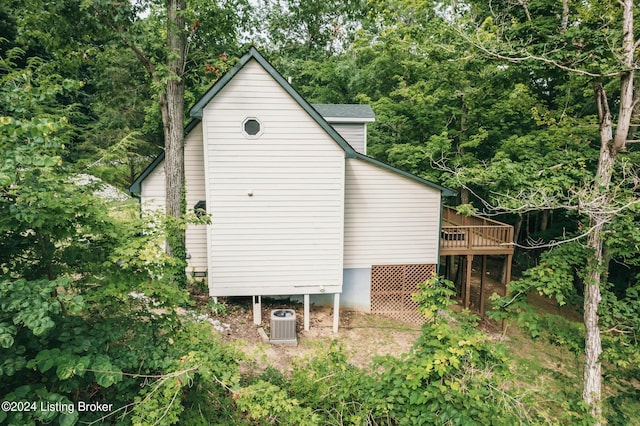 view of side of home featuring cooling unit and a deck