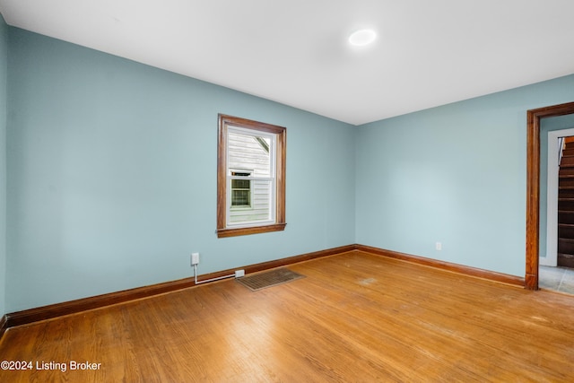 spare room featuring wood-type flooring