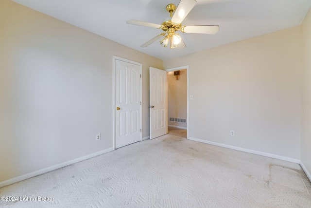 carpeted spare room with ceiling fan