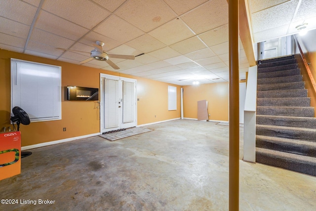 basement with a drop ceiling and ceiling fan