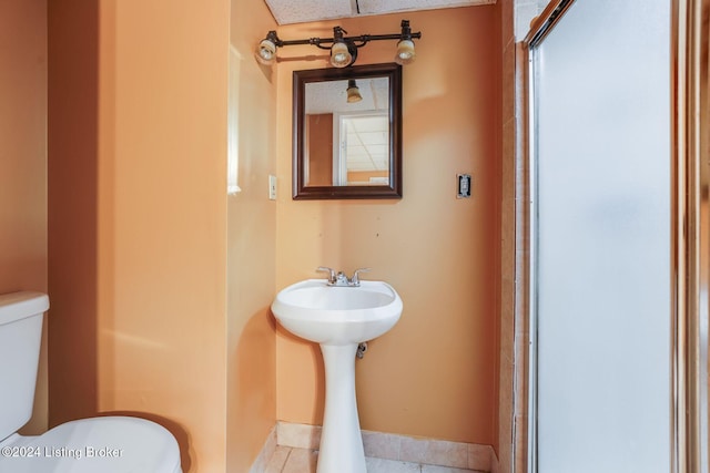 bathroom featuring tile patterned floors and toilet