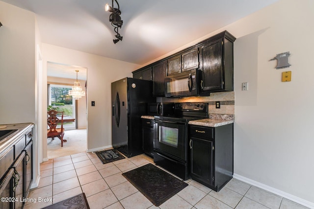 kitchen featuring light tile patterned floors, backsplash, hanging light fixtures, and black appliances