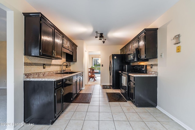 kitchen featuring decorative backsplash, dark brown cabinets, sink, black appliances, and light tile patterned floors