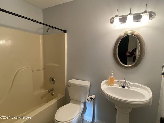 bathroom with bathing tub / shower combination and toilet