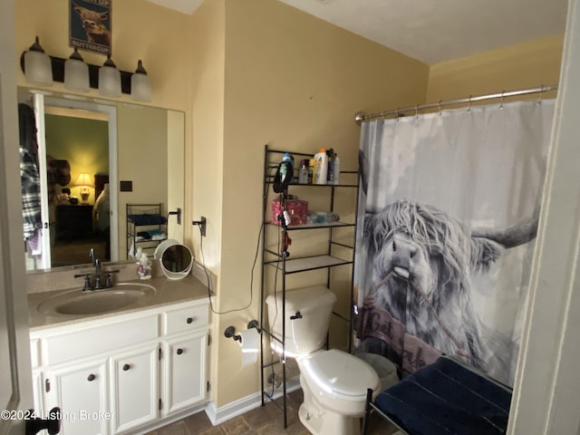 bathroom featuring toilet, vanity, and walk in shower